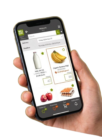 Hand holding a smartphone displaying the WEGOTRADE mobile app product ordering screen with milk, bananas, apples, and eggs